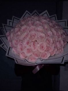 a bouquet of pink roses wrapped in plastic wrap