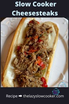 a sandwich with meat and vegetables on a white plate