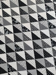 a black and white quilt with triangles on it