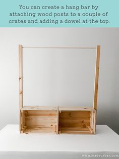 a wooden box sitting on top of a table with the words, you can create a hang bar by attaching wood posts to a couple of crates and adding a dowel at the top