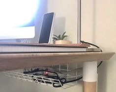 a laptop computer sitting on top of a wooden desk