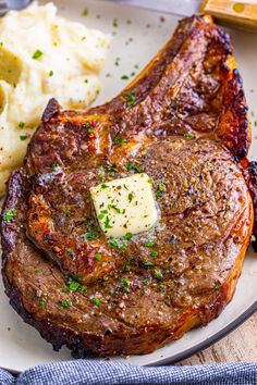 a plate with steak, mashed potatoes and gravy on it next to a fork