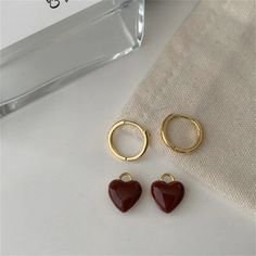 Fall in love with our Cute Burgundy Red Heart Pendant Earrings. These charming earrings feature a delicate burgundy red heart pendant that adds a touch of sweetness to any outfit. Perfect for expressing your love or adding a pop of color to your look. Red Heart Pendant Earrings, Trendy Red Heart Earrings For Gift, Trendy Heart Charm Earrings For Valentine's Day, Red Heart Charm Earrings, Red Heart Charm Earrings With Pendant, Trendy Red Dangle Heart Earrings, Red Heart-shaped Single Earring, Red Dangle Hoop Earrings For Valentine's Day, Single Red Heart-shaped Earring