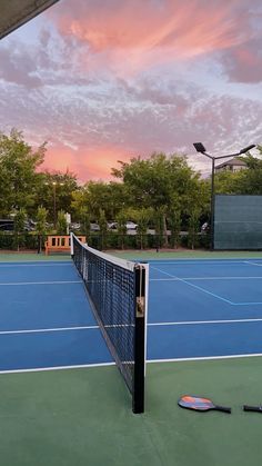 a tennis court with two racquets laying on the ground next to it