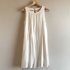 Nwt Color: Off White Size: Small Sleeveless Popover Style Lined Fabric: 100% Rayon Liner: 100% Polyester No Trades Off White Sleeveless Mini Dress For Day Out, Off-white Sleeveless Midi Dress For Vacation, Off White Sleeveless Sundress For Spring, White Flowy Midi Sleeveless Dress, Off White Sleeveless Midi Dress For Vacation, Chic Off-white Sleeveless Sundress, Cream Sleeveless Sundress For Daywear, White Sleeveless Sundress For Daytime, Off White Sleeveless Sundress Midi Dress