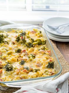 a casserole dish with broccoli, ham and cheese in it on a place mat