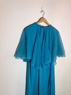 "Decorum By Irvin's Korny Light Blue Dress/ Gown / Plus Size Made is Canada  Size 22 1/2 Plus size This dress has a cape attached at the neck line for a formal look which is light weight  Belted Measurements taken while laying flat Pit to pit 24\" Arm hole 9\" Length from should to bottom 53\" Purchase price includes free shipping in Canada and the USA International shipping is available, please contact before purchase for shipping quote Any questions, just ask!  Vintage item, regular wear due to age should be expected Any known flaws/ markings will be listed No returns / exchanges, but please contact if there is an issue with your item" Blue Formal Dress With Cape Sleeves, Blue Formal Dresses With Cape Sleeves, Blue Gown With Cape Sleeves For Party, Blue Cape Dress For Party, Blue Flutter Sleeve Dress For Wedding, Blue Summer Dresses With Cape Sleeves, Flowy Cape Dress For Party, Light Blue Dress, Marine Uniform