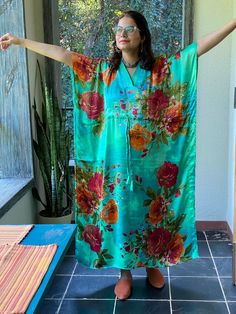 I made this Kaftan from a beautiful floral pattern in satin silk fabric. It is very soft with a nice flowy feel to it making you feel as if you are not wearing anything.It is so free flowing, that it will make you feel as if you aren't wearing anything at all ;)The beauty of the Kaftans is they will fit everyone so no need to worry about the size et all. All my Kaftans have deep necks(11-12 inches) so will fit all head sizes.However, the length of my kaftans will vary.I make all my kaftan styles Silk Summer Sleepwear For Home, Multicolor Silk Robe For Vacation, Green Bohemian Floral Robe, Silk V-neck Robe For Summer, V-neck Silk Summer Robe, Green Satin Sleepwear For Summer, Long Satin Summer Robe, Green Silk Kimono With Floral Print, Silk Summer Robe