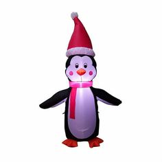 an inflatable penguin with a red hat and scarf on it's head