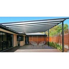 a patio covered in metal sheets with sliding glass doors on the side and an awning over it