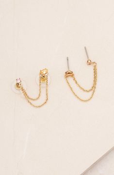 Warm 18-karat gold plates these chain drop earrings that adorn two piercings on each of your lobes with cubic zirconia. Designed for multiple piercings on each ear 1/8"W x 1/8"L studs; 2" length; 1/2" drop 18k-gold plate/cubic zirconia Imported Double Piercing Chain, Two Piercings, Piercing Chain, Gold Plates, Double Piercing, Chain Drop Earrings, Second Piercing, Crystal Green, Crystal Opal