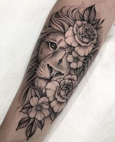 a black and white lion with flowers on his arm