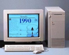 an old desktop computer sitting on top of a desk next to a keyboard and mouse