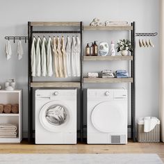 a washer and dryer sitting in front of a shelf filled with laundry items