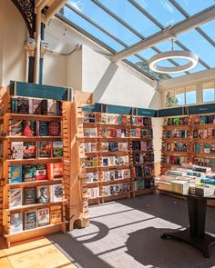 a room filled with lots of books under a glass roof