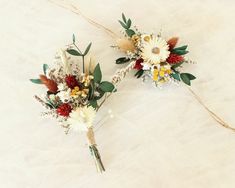 two bridal bouquets with dried flowers and greenery on the side, top view