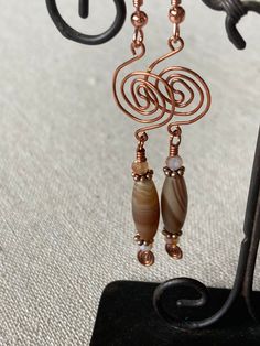 These fun copper spiral agate earrings are perfect to wear all year round. Very light, you will barely notice them. They would be a great gift for someone who loves copper and natural stones, especially agates. To maintain the highest level of hygiene, we cannot accept the return of any earrings. Elegant Brown Copper Wire Earrings, Bronze Copper Earrings With Dangling Beads, Bohemian Spiral Copper Earrings, Bohemian Copper Spiral Earrings, Handmade Spiral Copper Wire Earrings, Bohemian Spiral Copper Wire Earrings, Brown Patina Dangle Earrings, Rust-colored Copper Dangle Jewelry, Earrings Handmade Boho