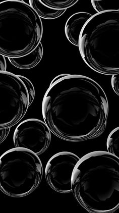 black and white photograph of glass bowls in the middle of a circle pattern on a black background