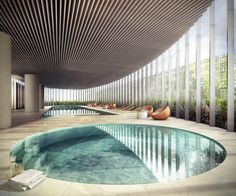 an indoor swimming pool surrounded by tall columns