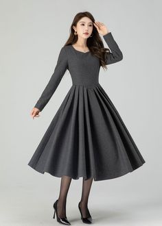 Elevate your winter style with our deep gray wool midi dress, featuring a charming swing silhouette and delicate pleats. The sophisticated gray hue exudes timeless elegance, and the premium wool fabric ensures both style and warmth. This versatile midi dress effortlessly transitions from day to night, making it a must-have choice for those who appreciate both fashion and comfort. Details: * 35% wool blend, 35% fiber and polyester, 30% nylon * Polyester lining * Big Round neckline * No pockets * Back zipper closure * Long sleeve * Perfect for autumn and winter * Dry clean SIZE GUIDE Size vary between Brand and Country Please get your body measurement with our Size Guide And Find your size in our Size Chart Size Guide https://etsy.me/3d3EmoM SIZE CHART  https://etsy.me/2zrjsS5 This Video of Solid Pleated Midi Dress For Winter, Gray A-line Winter Dresses, Winter A-line Dress With Pleated Skirt, Pleated Midi Dress For Winter, Elegant Full Skirt Winter Dress, Winter Midi-length Pleated Dress, Winter Midi Length Pleated Dress, Fall A-line Midi Dress With Pleated Hem, Gray Knee-length Winter Dress