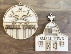 two wooden plaques depicting small towns and the american flag