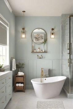 a white bath tub sitting next to a walk in shower