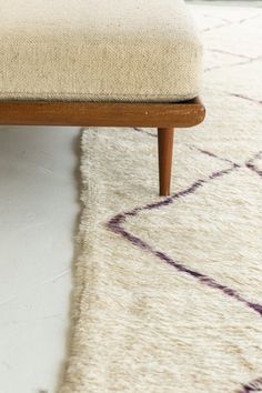 a close up of a bench on a rug