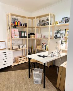 an office with shelving, desk and shelves full of books on it's sides