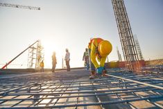 construction workers working on the roof of a building