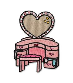 a patch with a heart on top of a pink chair and ottoman in the shape of a heart