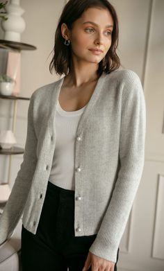 A timeless, versatile classic that layers beautifully with just about any outfit for an effortlessly chic look. Knit with supremely warm and lightweight cashmere, you won't want to leave home without it. V-neck cardigan with elegant ribbed knit. White pearlescent buttons. Hits at the hips. Wear open or buttoned up. FIT: Relaxed fit. Size down if you're between sizes. 100% LUXURY CASHMERE Elegant Soft Knit Cashmere V-neck Sweater, Elegant Fitted Ribbed V-neck Sweater, Elegant V-neck Fine Knit Cardigan, Elegant Soft Knit V-neck Sweater For Fall, Classic V-neck Fine Knit Cardigan, Elegant Cashmere V-neck Cardigan, Elegant V-neck Sweater For Winter, Classic V-neck Soft Knit Outerwear, Elegant Cashmere V-neck Sweater For Work