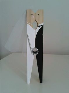 a clock made to look like a pair of scissors in the shape of a man