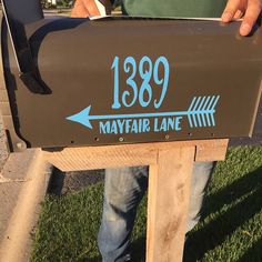 a mailbox with an arrow pointing to the right, and may fair lane on it