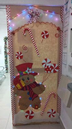 a christmas door decorated with candy canes and a teddy bear