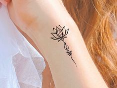 a woman's arm with a tattoo on it that says love and a flower