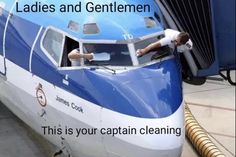 a man is leaning out the window of a blue and white train that says ladies and gentlemen this is your captain cleaning