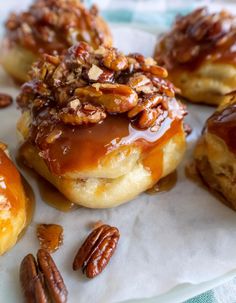 some pecans are on top of doughnuts covered in caramel and pecans