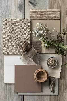 a table topped with lots of different items on top of a wooden floor next to a plant