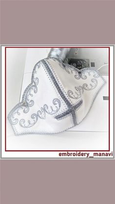 an embroidered white handkerchief with the word love on it and a red border around it