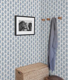 a blue and white wallpaper in a bathroom with an animal print on the wall