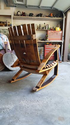 a wooden rocking chair sitting inside of a garage