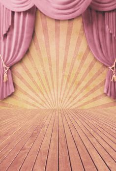 an empty stage with pink curtains and wooden floor in front of a yellow sunburst background