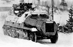 an armored vehicle driving through the snow