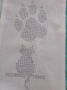 a cross - stitch pattern is displayed on a piece of paper