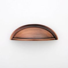 an oval wooden door handle on a white wall, with the top half painted brown