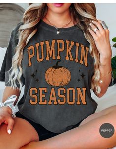 Embrace the cozy charm of fall with our Vintage Pumpkin Patch Tee! This adorable shirt features a nostalgic pumpkin design that brings back all the feels of crisp autumn air, hayrides, and harvest festivals. Made from soft, breathable fabric, it's perfect for layering under your favorite flannel or wearing on its own for a casual, cute look. Celebrate the season in style with this timeless piece that's sure to become your go-to fall favorite! Soft-washed Black Tops For Fall, Soft-washed Black Top For Fall, Spooky Graphic Print Top For Fall, Spooky Graphic Print Tops For Fall, Vintage Graphic Print T-shirt For Fall, Vintage Black T-shirt For Fall, Retro Black T-shirt For Fall, Trendy Soft-washed Fall Tops, Trendy Soft-washed Tops For Fall