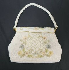 "This is a vintage Debbie Purse/Handbag Made of Opalescent Glass Beads in a flower pattern Made by Debbie in Hong Kong. 1960's estimated Nice Mid Century look! Both the strap and the purse are beaded Has gold tone metal clasps that connect strap to purpose and gold accented opening clasp Purse opens and snaps back into place. Seems to hold by magnets? Measures 9\" wide and approx. 6\" tall (excluding straps) Condition Details: Has minor wear to the outside with a few loose beads. Inside material Vintage Beaded Beige Bags, Retro Beaded Bags For Wedding, Retro Beaded Bag For Wedding, Retro Beaded Wedding Bag, Vintage Formal Bags For Spring, Vintage Formal Bag For Spring, Formal Vintage Bags For Spring, Beaded Handbag, Evening Handbag