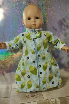 a baby doll wearing a green and blue outfit