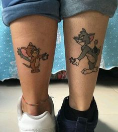 two people with tattoos on their legs, one has a cat and the other has a mouse