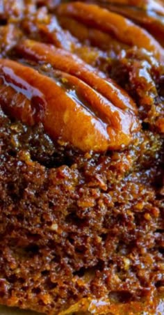 a close up view of some food on a white plate with sauce and pecans